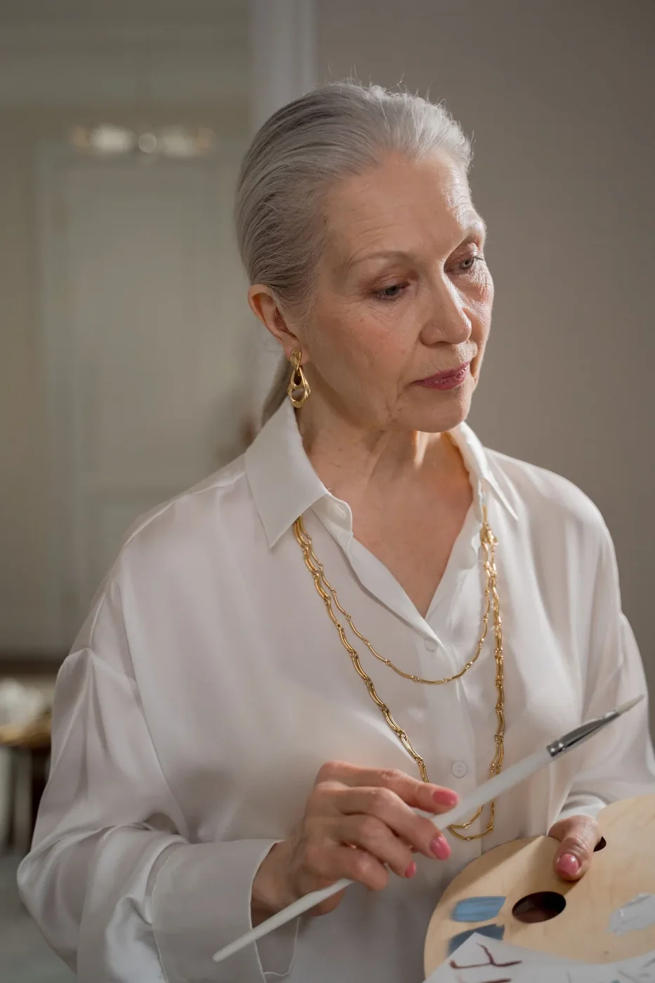 An older woman enjoying painting at home