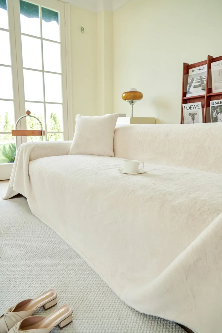 A light-filled lounge with a cream sofa and soft cushions