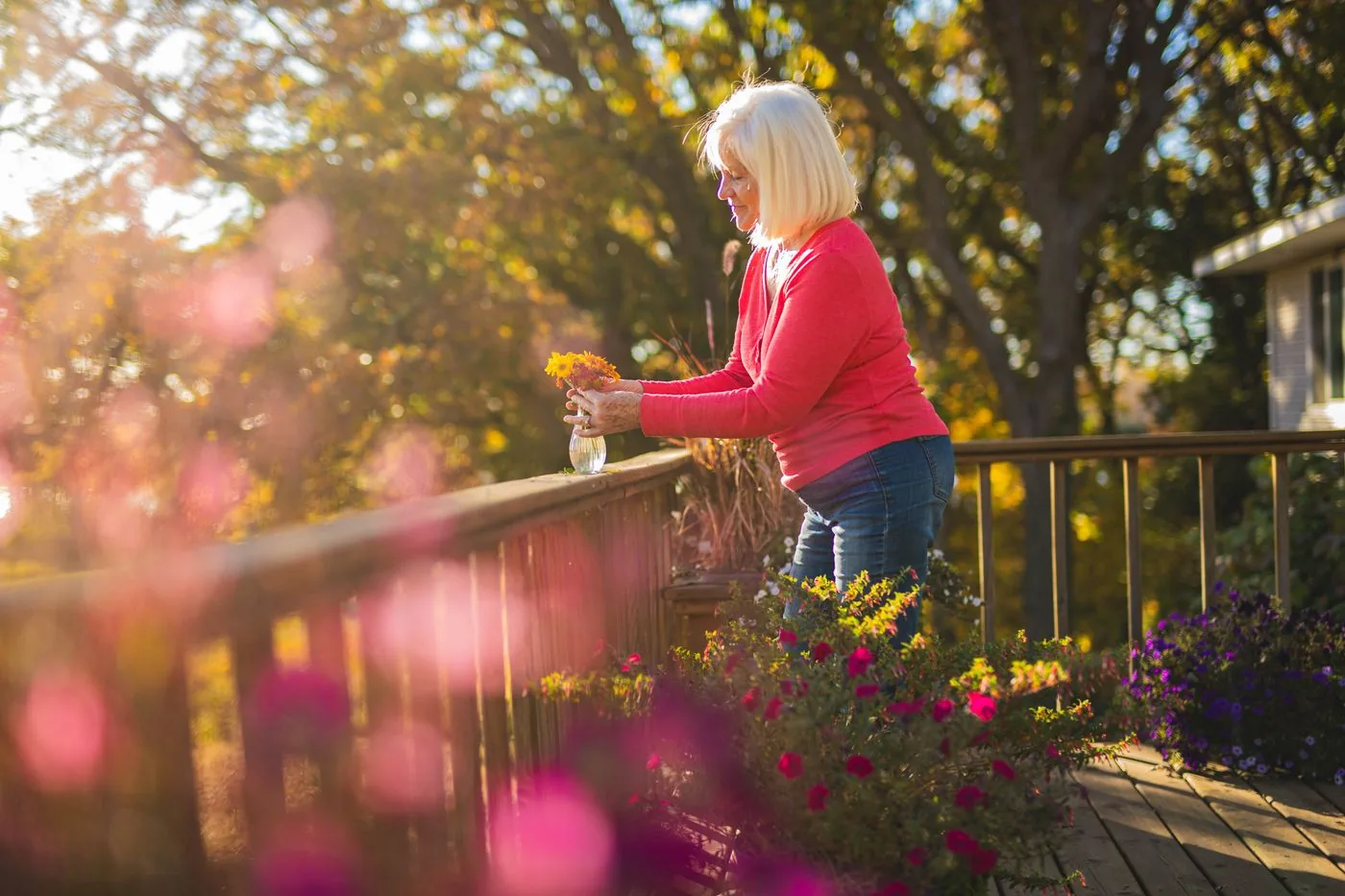 A woman tending plants in a sunny garden